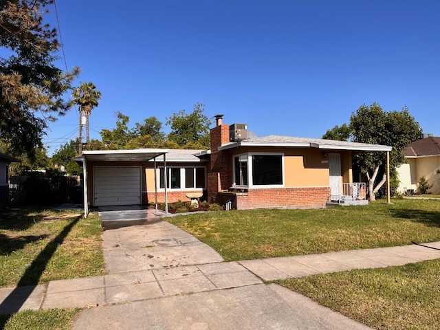 view of front of house featuring a garage, a front yard, and a carport