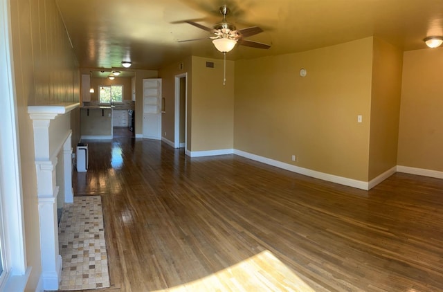 unfurnished living room with ceiling fan and dark hardwood / wood-style floors