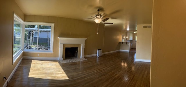 unfurnished living room featuring dark hardwood / wood-style floors and ceiling fan