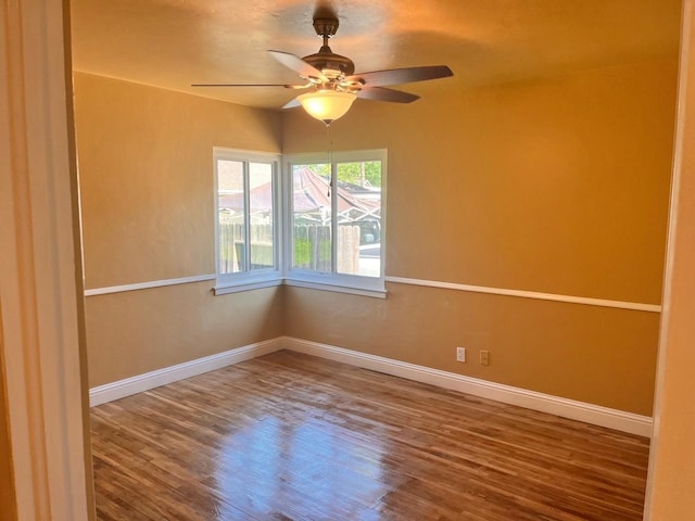 empty room featuring ceiling fan and hardwood / wood-style floors