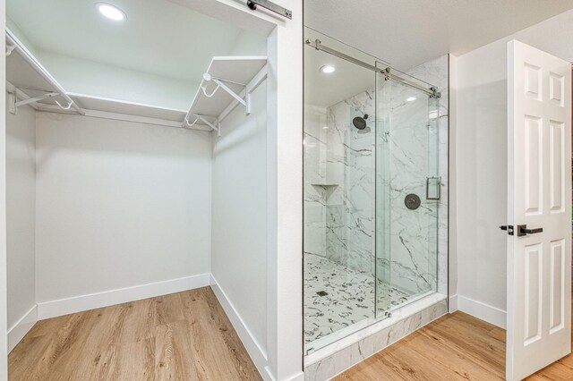 bathroom featuring walk in shower and hardwood / wood-style floors