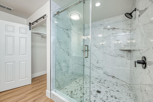 bathroom featuring hardwood / wood-style flooring and an enclosed shower