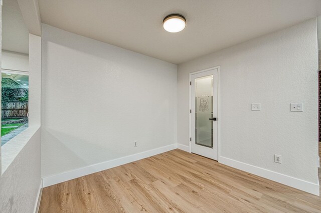 empty room with light hardwood / wood-style flooring