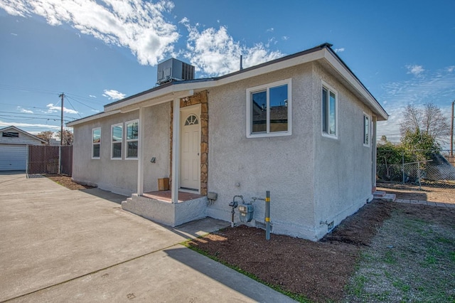 bungalow featuring central air condition unit and a patio area