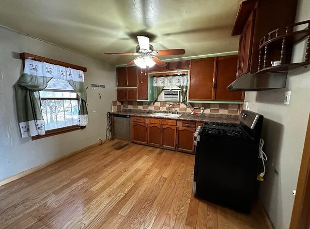 kitchen with sink, backsplash, ceiling fan, stainless steel appliances, and light wood-type flooring