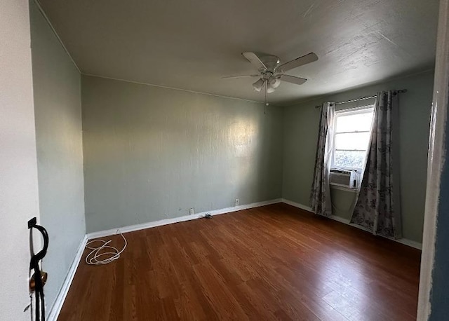 unfurnished room with hardwood / wood-style flooring, ceiling fan, and cooling unit