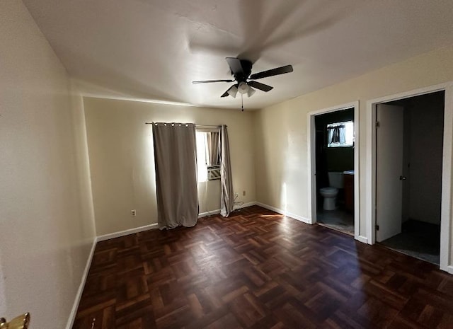 unfurnished room featuring ceiling fan and dark parquet floors