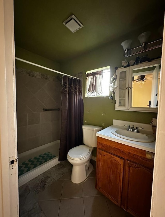 bathroom featuring a shower with shower curtain, vanity, toilet, and tile patterned flooring