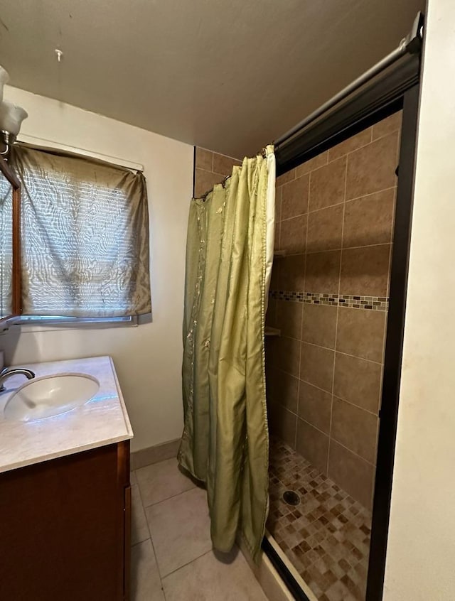 bathroom featuring tile patterned flooring, vanity, and a shower with curtain