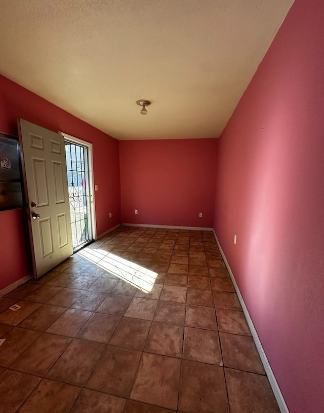 foyer featuring dark tile patterned floors