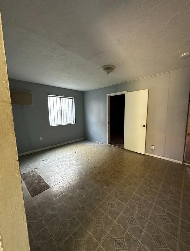 spare room with a textured ceiling