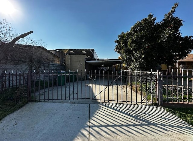 view of gate featuring a carport