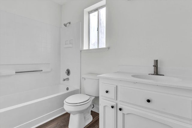 full bathroom featuring vanity, hardwood / wood-style flooring, bathing tub / shower combination, and toilet