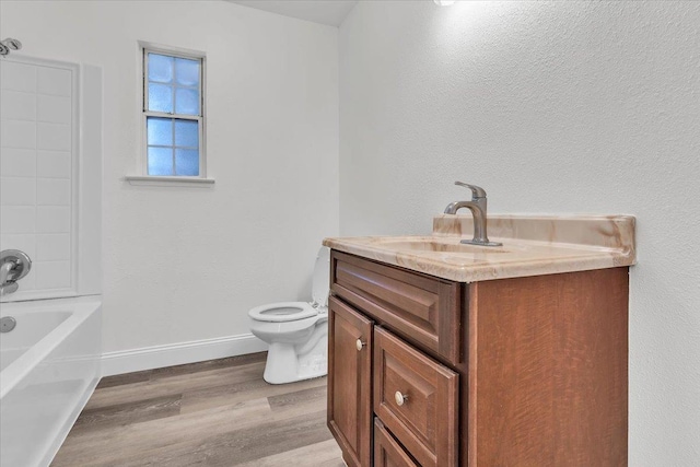 full bathroom with vanity, hardwood / wood-style floors, shower / bathtub combination, and toilet