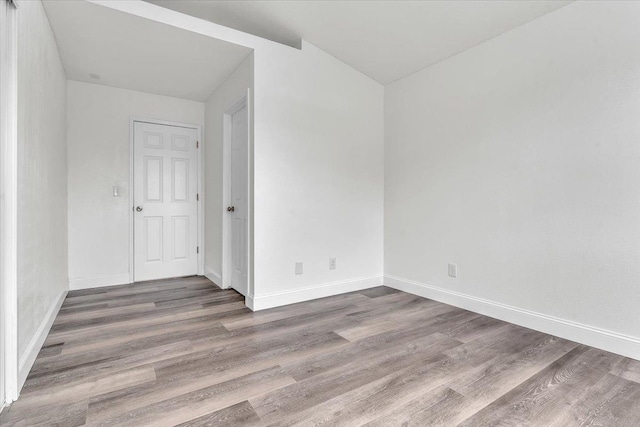 unfurnished room featuring hardwood / wood-style flooring