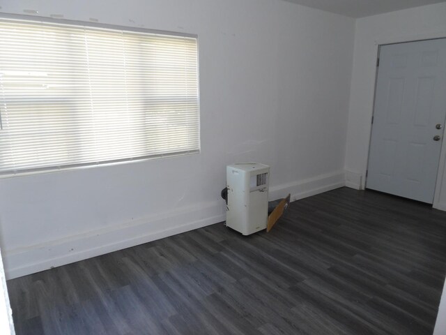 unfurnished room featuring dark hardwood / wood-style flooring