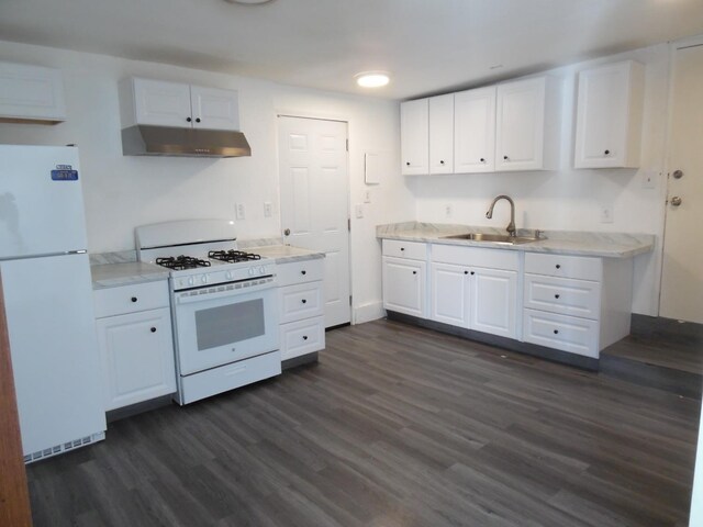 kitchen featuring sink, white cabinets, and white appliances