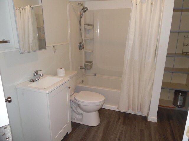 full bathroom with vanity, toilet, hardwood / wood-style floors, and shower / bath combo with shower curtain