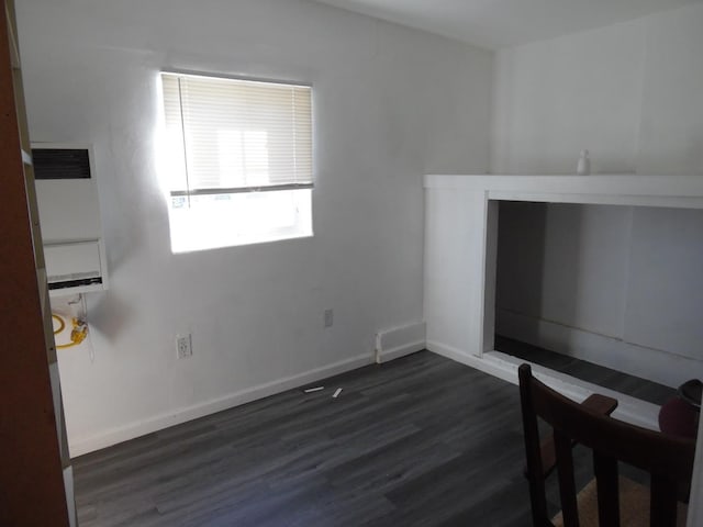 unfurnished living room featuring dark hardwood / wood-style flooring