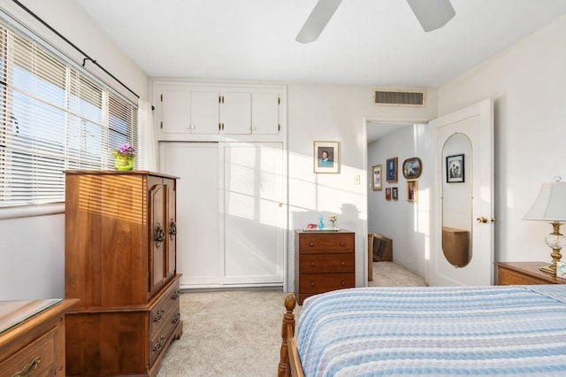 bedroom featuring ceiling fan and light colored carpet