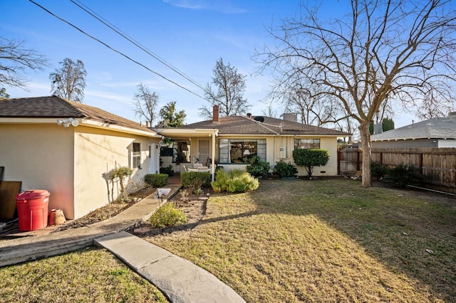 rear view of property featuring a lawn