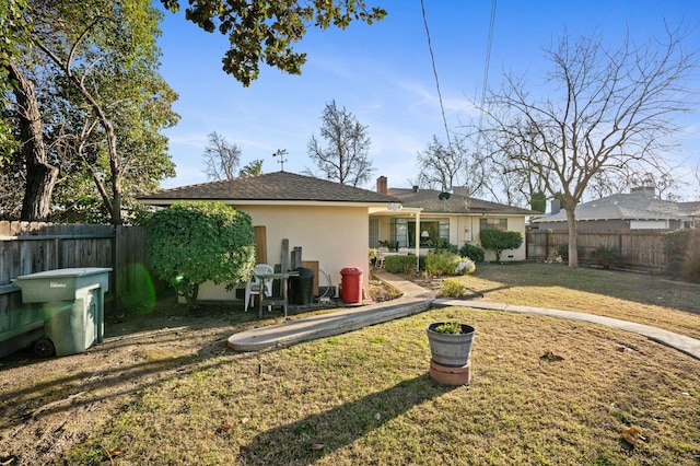 rear view of property featuring a yard