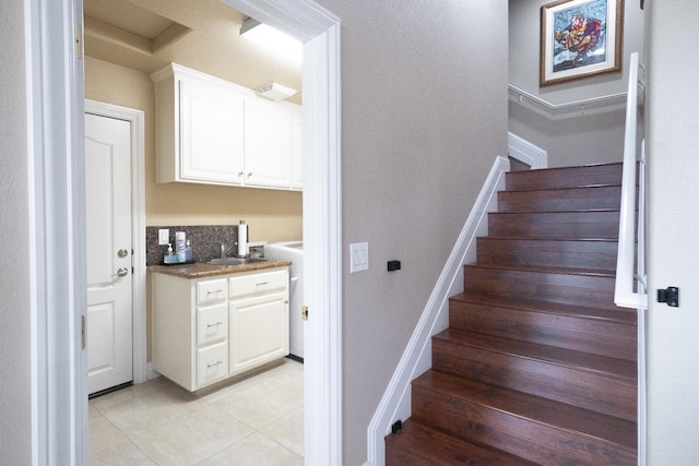 stairs with sink and tile patterned floors