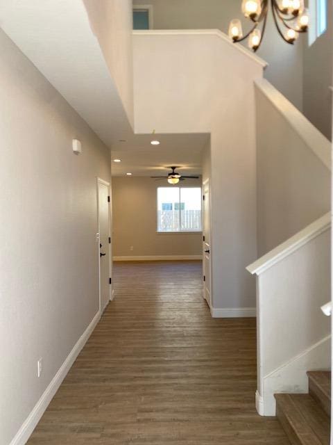 corridor featuring dark hardwood / wood-style floors and a chandelier