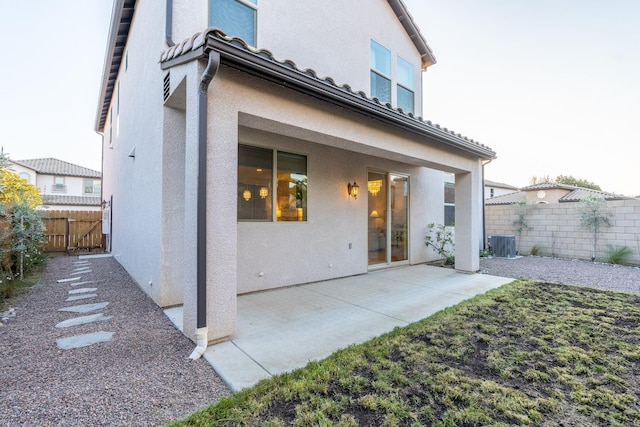 back of house with central AC and a patio area