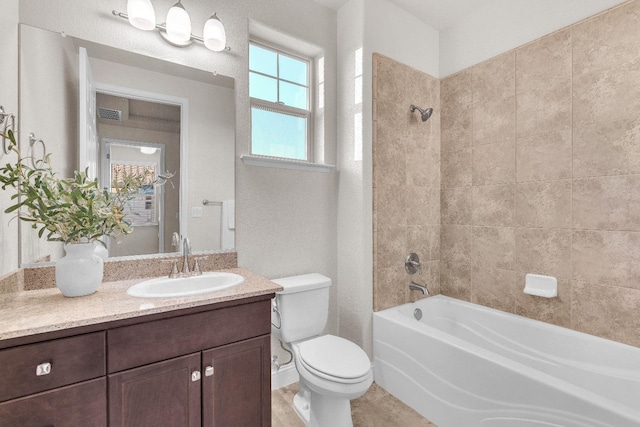 full bathroom with tiled shower / bath combo, vanity, tile patterned flooring, and toilet