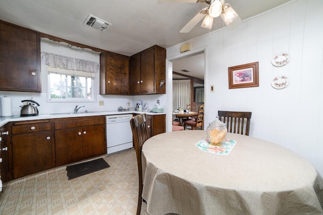 kitchen with light countertops, visible vents, white dishwasher, and a sink