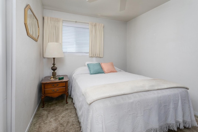 carpeted bedroom featuring ceiling fan and baseboards