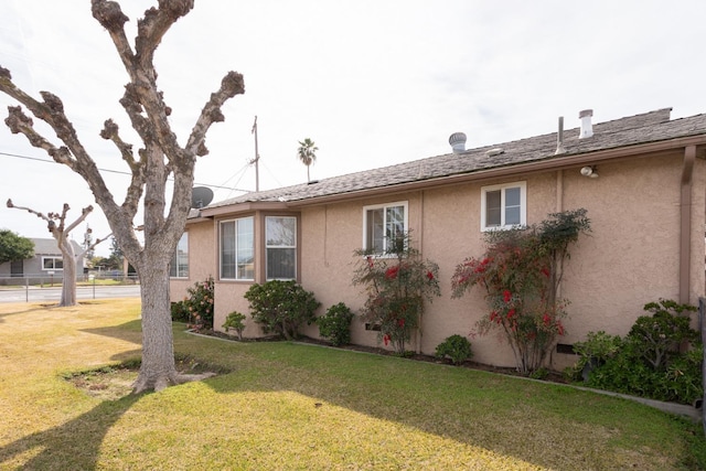 view of home's exterior featuring a yard and stucco siding