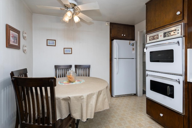 dining space with a ceiling fan and light floors