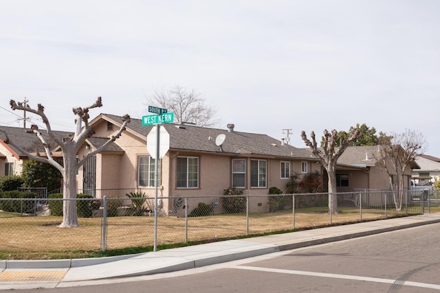 single story home featuring fence private yard, a front lawn, and stucco siding