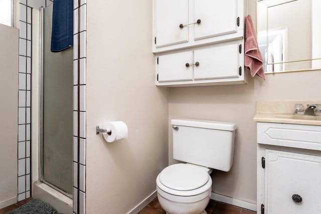 full bathroom featuring tile patterned flooring, toilet, vanity, baseboards, and a shower stall