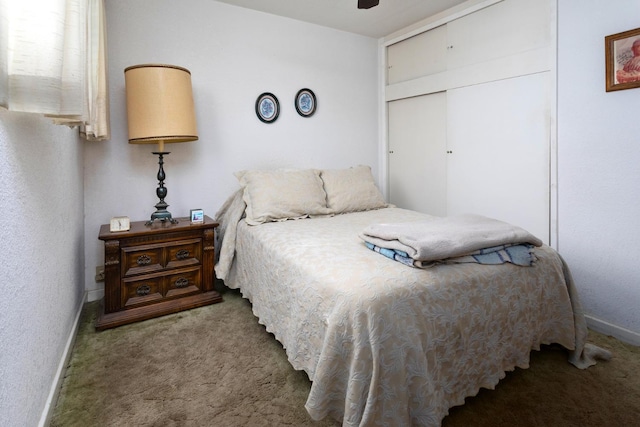 bedroom with a closet, carpet flooring, ceiling fan, and baseboards