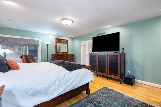 bedroom with hardwood / wood-style floors and a closet