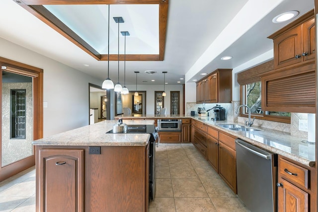 kitchen with sink, stainless steel dishwasher, a kitchen island with sink, and decorative light fixtures