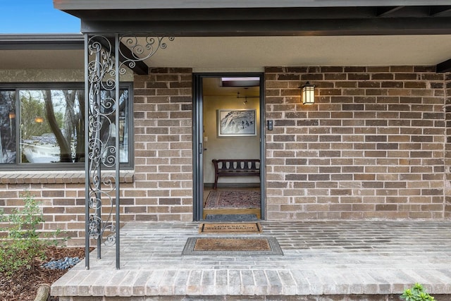 view of exterior entry with a porch