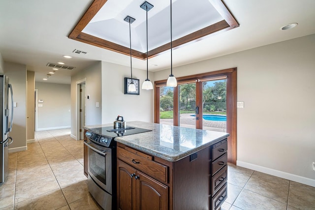 kitchen with a kitchen island, appliances with stainless steel finishes, decorative light fixtures, dark brown cabinetry, and a raised ceiling