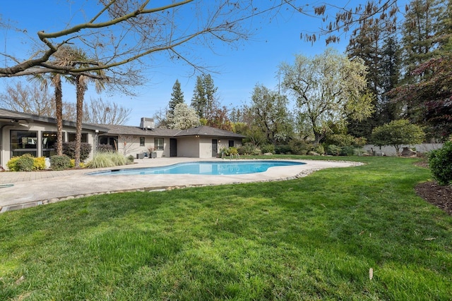 view of pool featuring a yard and a patio area