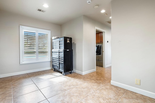 spare room with light tile patterned flooring and washer / clothes dryer