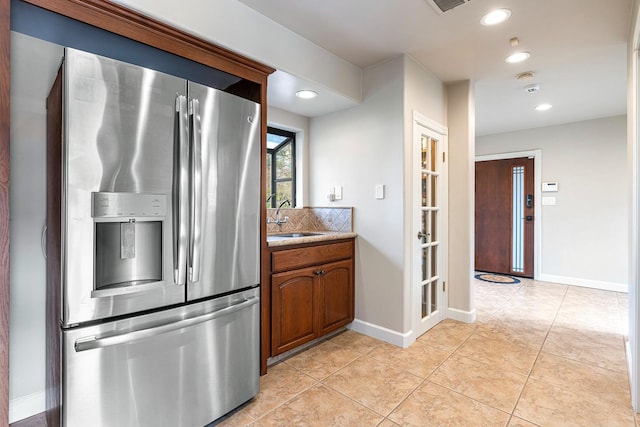 kitchen with sink, stainless steel fridge, and light tile patterned flooring