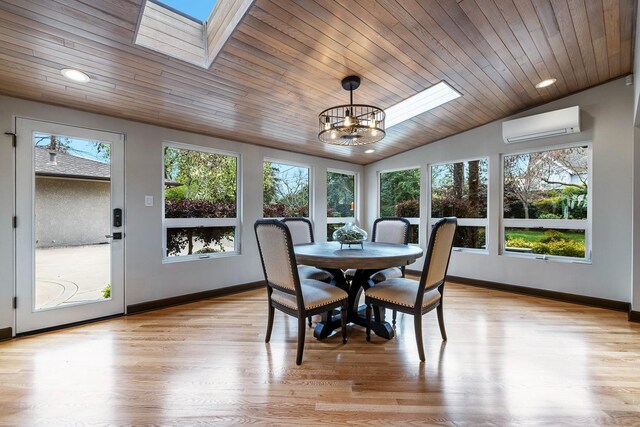 sunroom featuring lofted ceiling with skylight, a wall mounted AC, wood ceiling, and an inviting chandelier