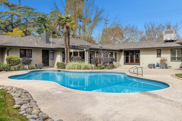 view of swimming pool featuring central AC unit and a patio area