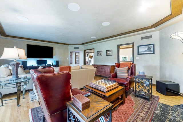 living room featuring ornamental molding and light hardwood / wood-style floors