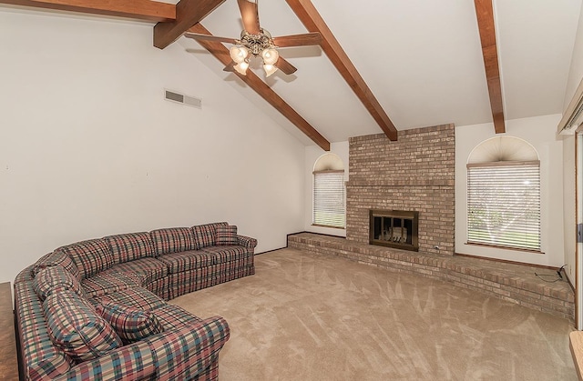 living room featuring ceiling fan, a brick fireplace, light carpet, and beam ceiling