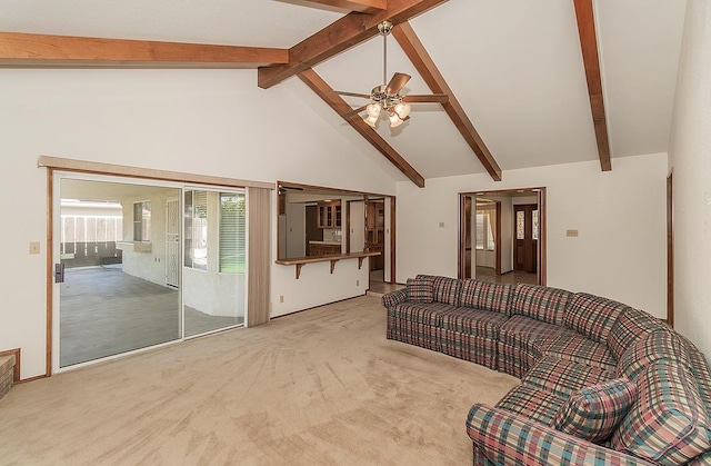 carpeted living room with ceiling fan, high vaulted ceiling, and beamed ceiling