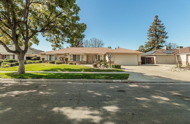 single story home with a garage and a front yard